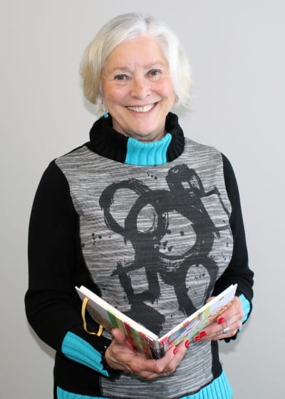Dianne Mcconnell Standing With A Book In Her Hands